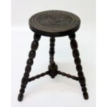 A carved oak stool, on bobbin turned legs, height 55cm.