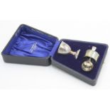 A silver child's christening set, comprising an eggcup, a spoon and a napkin ring, cased,