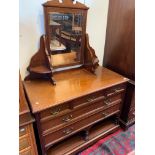 An Edwardian walnut dressing table, with three short and two long drawers,