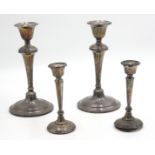 Two pairs of filled silver candlesticks, one 21cm, the other 14cm, damage.
