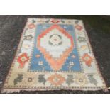 A Turkish rug, the indigo field with a large polychrome medallion,