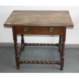 An oak side table, 19th century, with a single frieze drawer on barley twist legs and stretchers,