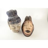 A painted tribal wood mask, 37 x 23cm and a South East Asian carved wood head of a lady,