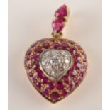 A yellow gold heart pave set with diamonds and rubies,