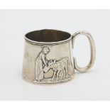 A tiny silver christening mug embossed with a young milkmaid feeding a calf,