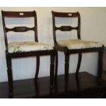 A pair of Regency mahogany brass inlaid dining chairs.