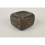 A Queen Anne copper weight of near cube form on one side a portcullis, on another royal arms,