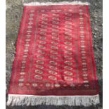 A Pakistan rug, with fifteen rows of three medallions, secondary guls, within a sunburst gul border,
