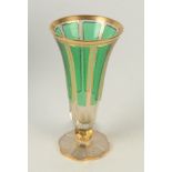 A 19th century Bohemian trumpet vase, in cut glass with green overlay and gilding, height 23 cm.