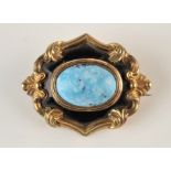 A Victorian memoriam gold and black enamel brooch, at the centre a turquoise cabochon, dated 1864.