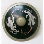 A circular metal shield painted with two griffins, diameter 58cm, depth 13cm.