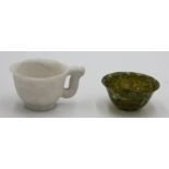 A Chinese carved stone cup and a Chinese finely turned jade tea bowl.
