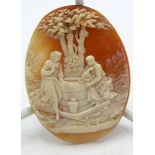 An unmounted carved shell cameo, figures at a well, 60 x 45mm.