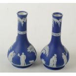 A pair of Wedgwood blue jasper bud vases, decorated with classical scenes, height 17.5cm.