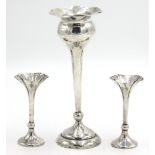 A pair of filled silver spill vases and a silver bud vase.
