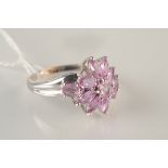 A 14ct white gold ring set a pink stone flowerhead.