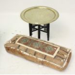 An Egyptian brass circular tray, 20th century, on carved folding stand, tray diameter 59cm,