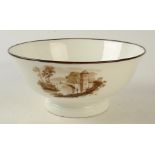 An 18th century Swansea porcelain bowl painted with three sepia landscape vignettes,