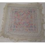 A Chinese silk embroidered shawl, decorated with figures and pagodas,
