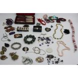 Military badges, costume jewellery including a pilgrim pendant etc.