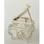 A Dresden style porcelain flower encrusted box, in the form of a grand piano, width 11cm.
