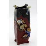 A Japanese Sumida Gawa square section vase, applied with three clambering monkeys in relief,