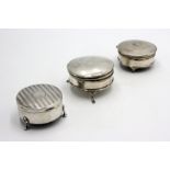 Three silver ring boxes each with hinged lid and three cabriole feet.