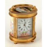 A gilt brass and porcelain oval carriage clock, the dial signed 'Elliott & Son London',
