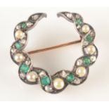 A diamond, emerald and pearl set crescent brooch with twin serpentine bands.