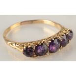 A Victorian style 18ct gold amethyst set ring, the stones separated by tiny diamonds.
