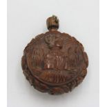 A European coquilla nut perfume bottle, carved with a male and a female portrait, height 5cm.