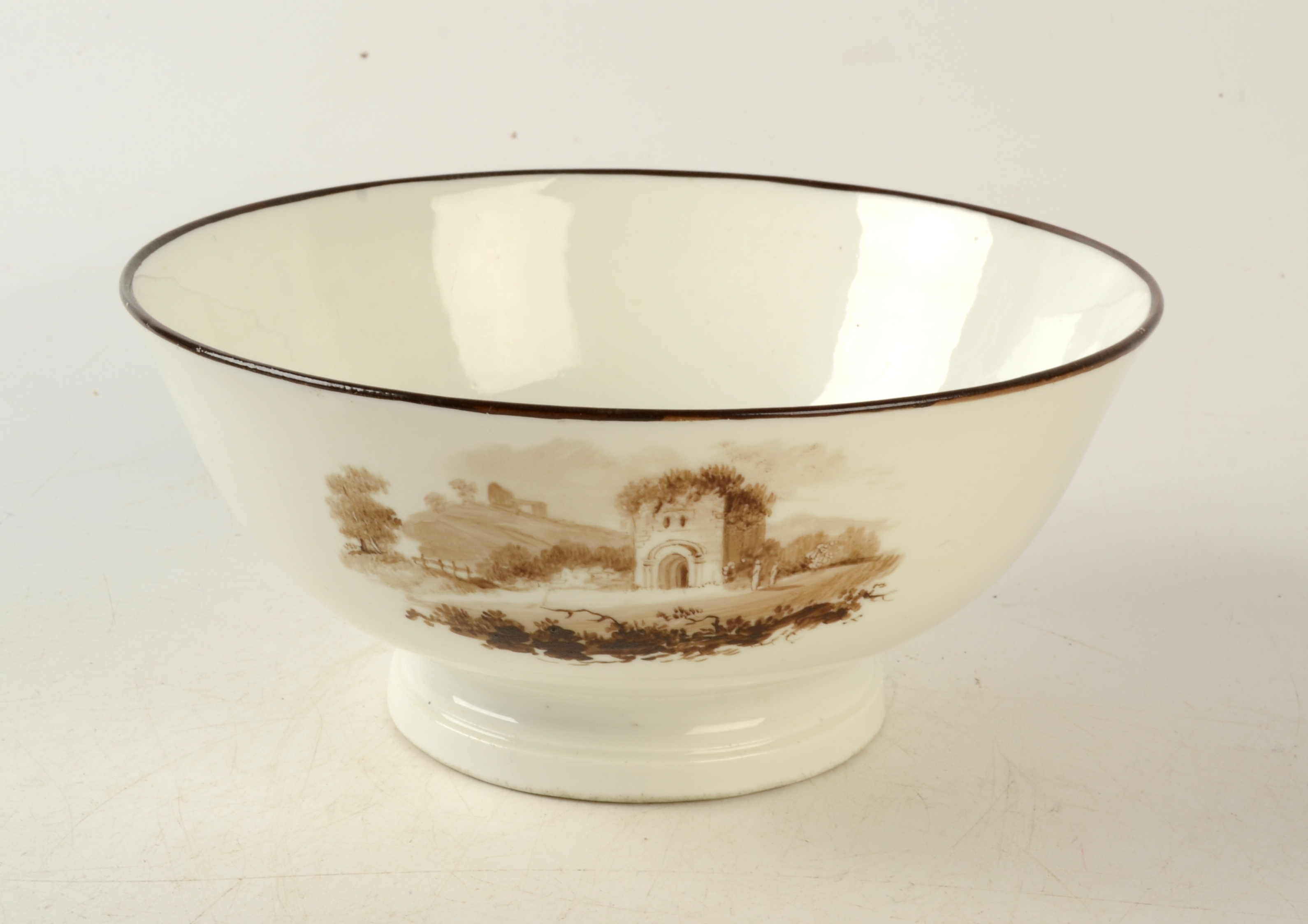 An 18th century Swansea porcelain bowl painted with three sepia landscape vignettes, - Image 2 of 4