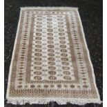 A Pakistan rug, the ivory ground with sixteen rows of three octagonal guls,