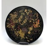 A late Victorian circular plaque, painted with a variety of flowers, diameter 57cm.