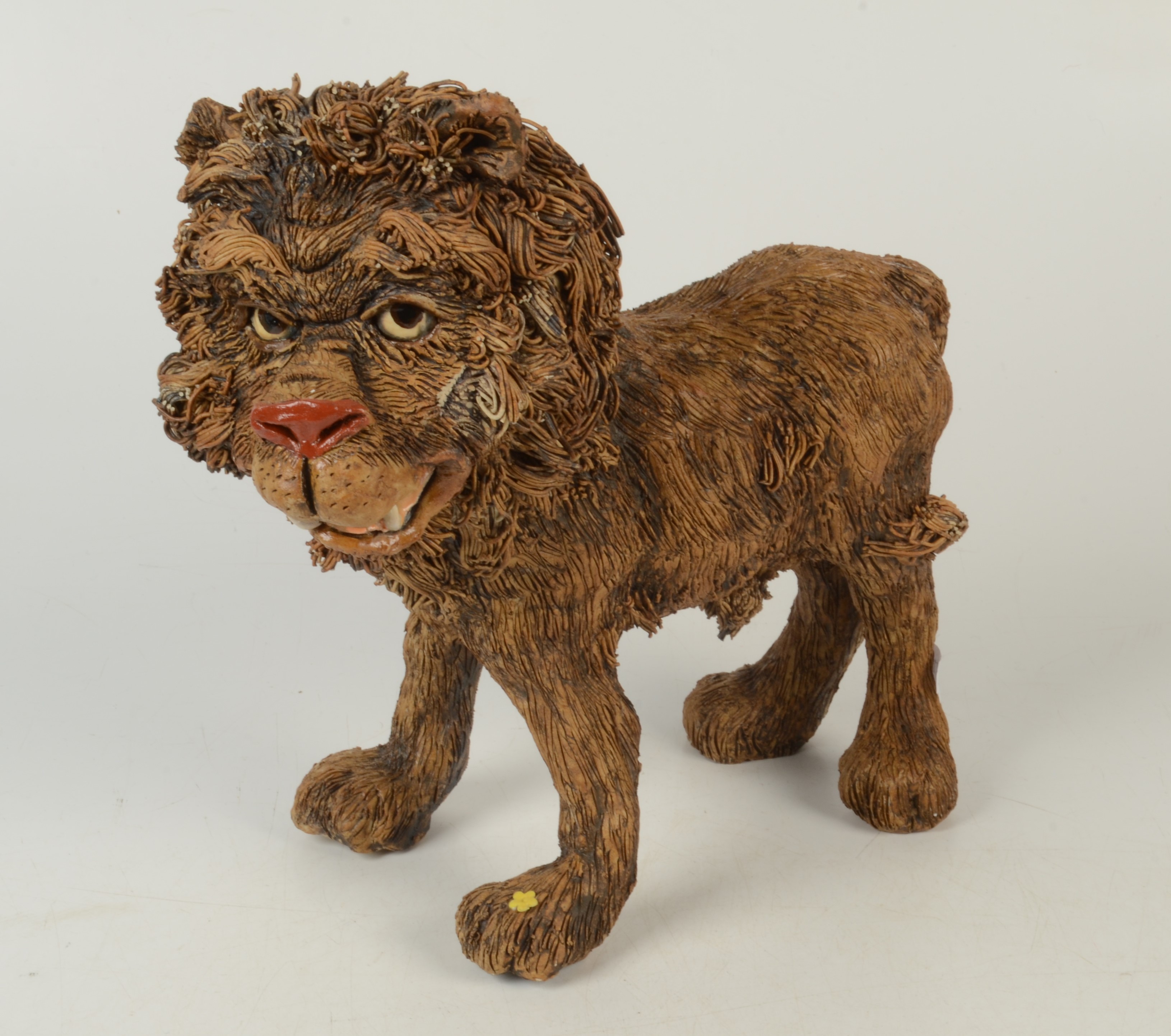 A pottery figure of a lion, mid 20th century,