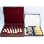 A set of twelve Victorian engraved dessert knives and forks with carved ivory handles in walnut