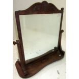 A Regency mahogany dressing table mirror, with swept and carved top rail
