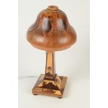 A Brazilian inlaid table lamp, with olive wood shade, height 38cm, width 20cm.