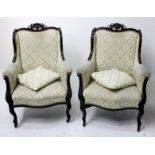 A pair of Edwardian mahogany upholstered armchairs, height 34cm.