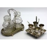A four section egg cruet and a pair of cut glass pickle jars in EPNS stand, with pierced gallery.