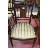 A pair of Edwardian inlaid mahogany armchairs.