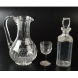 A 19th century cut glass water jug, height 25cm, a crested decanter and a matching glass.