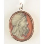 A classical portrait of a turbaned bearded man painted on a coral red ground in a pendant with gold