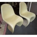 Two Verner Panton white plastic chairs, height 83cm, width 49cm, depth 53cm.