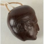 A carved wood eastern toggle in the form of a head, height 5.5cm.