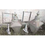 A pair of copper exterior lanterns of tapered square form with cast metal brackets,