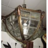 A 1920s anodised brass hanging light fitting, with angular leaded glass panels with bevelled edges,