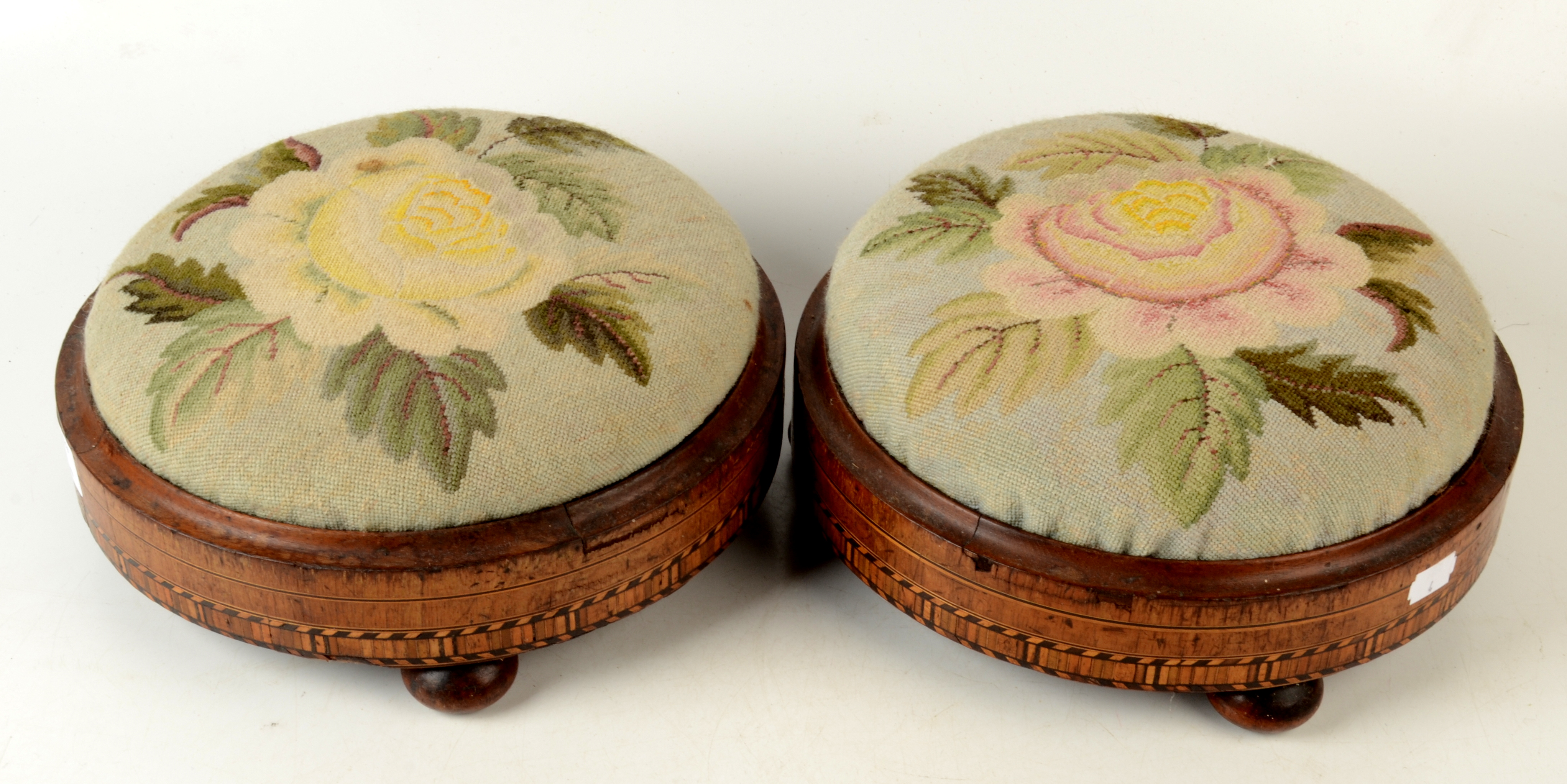 A pair of Victorian inlaid walnut footstools,