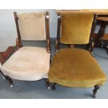 A pair of Victorian walnut nursing chairs, with a padded back and seat on turned tapering legs.