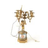 A French ormolu and porcelain cherub candelabra, 19th century, height 66cm.